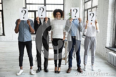 Smiling African American businesswoman standing with unknown people Stock Photo