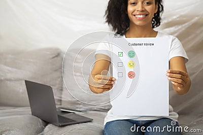 Smiling african american female leaves excellent customer review Stock Photo