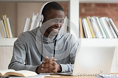 Smiling black male watch online training course at laptop Stock Photo