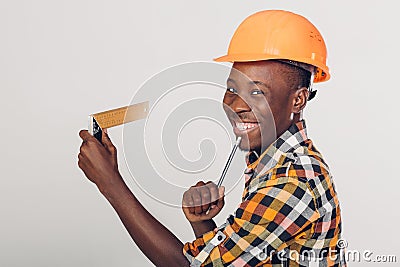 African-American builder uses measuring tape Stock Photo