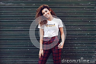 Smiling arab girl in casual clothes in the street. Stock Photo