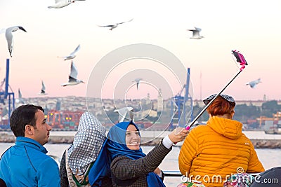Smiling Arabic Ladies taking self Portrait with Sea Gulls Editorial Stock Photo
