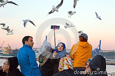 Smiling Arabic Ladies taking self Portrait with Sea Gulls Editorial Stock Photo