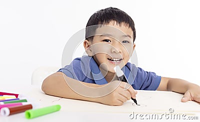 Smiling asian child schoolboy studying and drawing at home Stock Photo