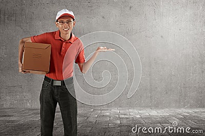 Smiling asian courier man delivery holding package with open arm Stock Photo