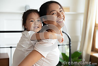 Young Asian mom play with little biracial daughter Stock Photo