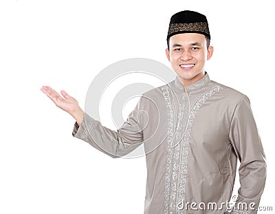 Smiling asian muslim man presenting copy space Stock Photo