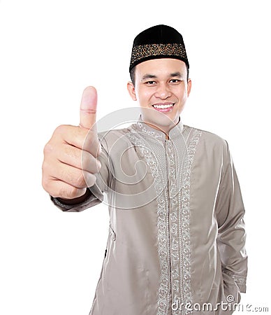 Smiling asian muslim man showing thumb up Stock Photo