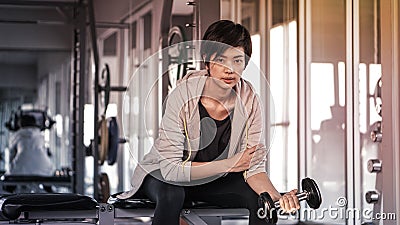Smiling Asian short hair woman fitness dumbbell lifting. exercise Stock Photo