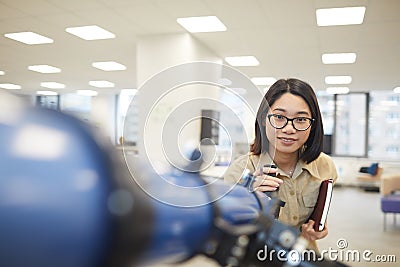 Smiling Asian Student Posing with Telescope Stock Photo