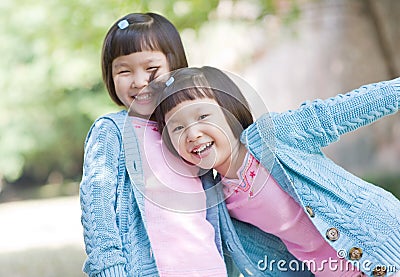 Smiling asian twin girls Stock Photo