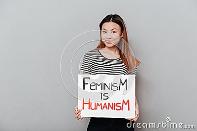 Smiling asian woman holding poster with slogan Stock Photo