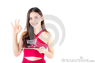 Smiling asian woman in red dress holding tablet with glad girl g Stock Photo