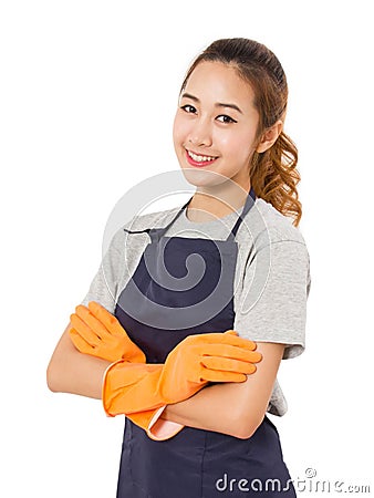 Smiling Asian Woman Standing With Arms Crossed Wearing Apron And Rubber Gloves. Stock Photo