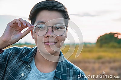 Smiling Asian women are short hair in eyeglasses standing on the field, only one portrait Lesbian Stock Photo