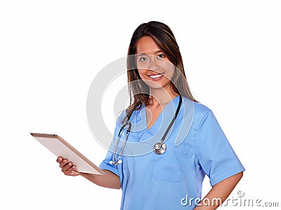 Smiling asiatic nurse woman using her tablet pc Stock Photo