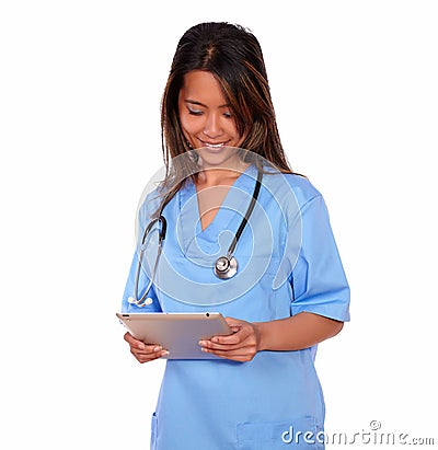 Smiling asiatic nurse woman working on tablet pc Stock Photo