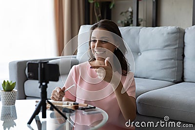 Smiling attractive arabic indian female blogger recording beauty video. Stock Photo