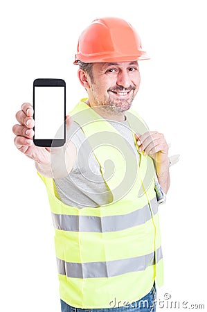 Smiling attractive builder holding smartphone with blank screen Stock Photo