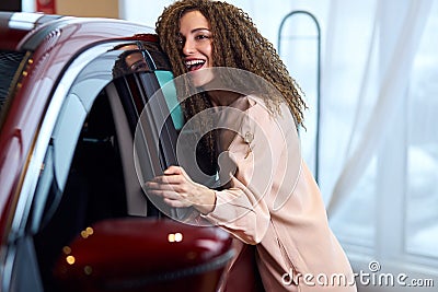 Smiling attractive girl adores her vehicle Stock Photo