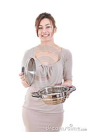 Smiling attractive woman opening pot for cooking in the kitchen Stock Photo