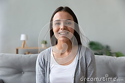 Smiling attractive young lady looking talking to camera at home Stock Photo