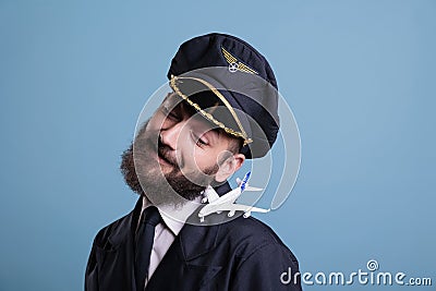 Smiling aviator in uniform with airplane model on shoulder Stock Photo