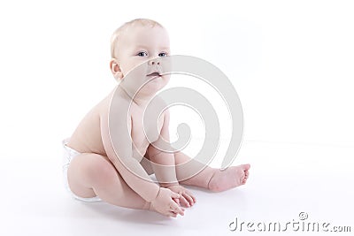 Smiling baby-boy in a diaper sitting on the floor Stock Photo