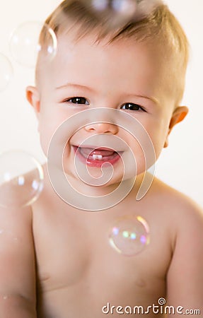 Smiling baby with bubbles Stock Photo