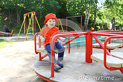 Smiling baby on merry-go-round Stock Photo