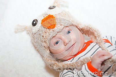 Smiling Baby in Owl Hat Stock Photo