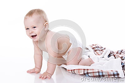 Smiling baby playing on plaid Stock Photo
