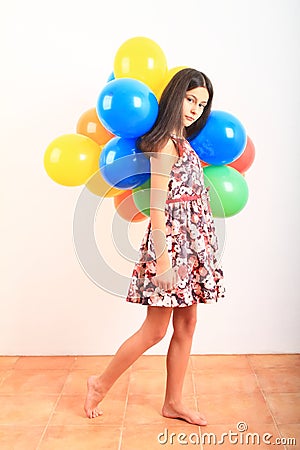 Girl walking with inflating balloons Stock Photo