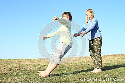 Smiling kids playing trust game Stock Photo