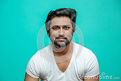 Smiling bearded brutal Indian guy looking at the camera Stock Photo