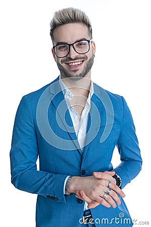 Smiling bearded man in blue suit holding hands and laughing Stock Photo