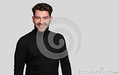 Smiling bearded young male model dressed casually Stock Photo