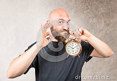 Smiling beared man with a reveille Stock Photo