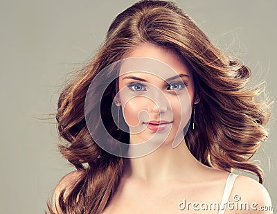 Smiling Beautiful girl, brown hair with an elegant hairstyle , hair waves ,curly.