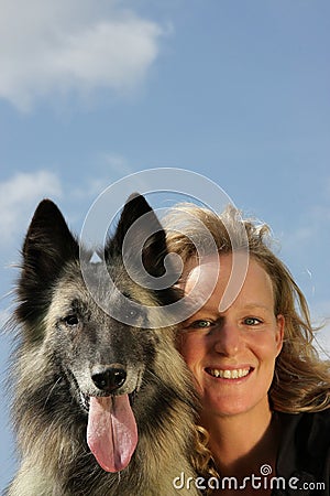 Smiling beautiful woman with Belgian shepherd Stock Photo
