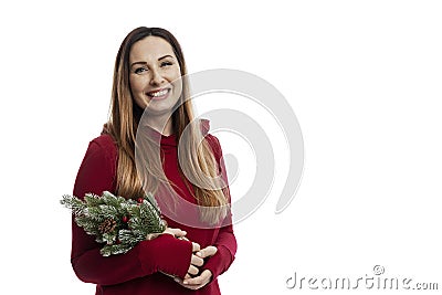 Smiling beautiful woman in a red dress with a small Christmas tree in her hands. Traditional winter holidays. Isolated on white Stock Photo