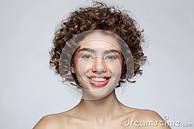 Smiling beautiful young girl with curly hair Stock Photo