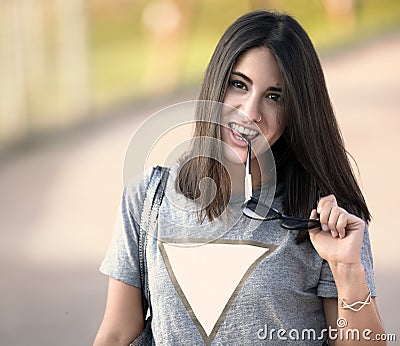 Beautiful girl with her sunglasses in her hand Stock Photo