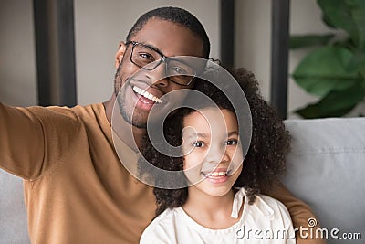 Smiling black father and child taking selfie looking at camera Stock Photo