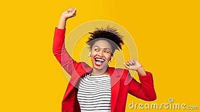 Smiling black girl listening to music and dancing Stock Photo