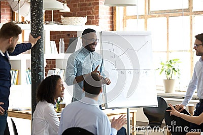 Smiling black leader or coach giving presentation at business meeting Stock Photo