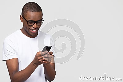 Smiling black man using phone isolated on background with copyspace Stock Photo