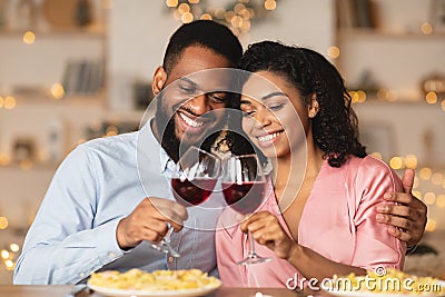 Smiling black woman and man drinking wine on a date Stock Photo