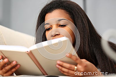 Smiling black woman read story book at home Stock Photo