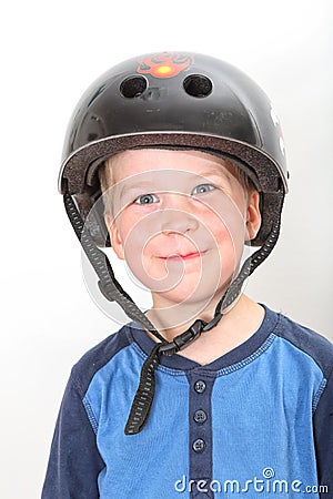 Smiling blond boy wearing black skate helmet Stock Photo
